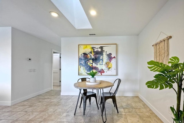 dining room with a skylight