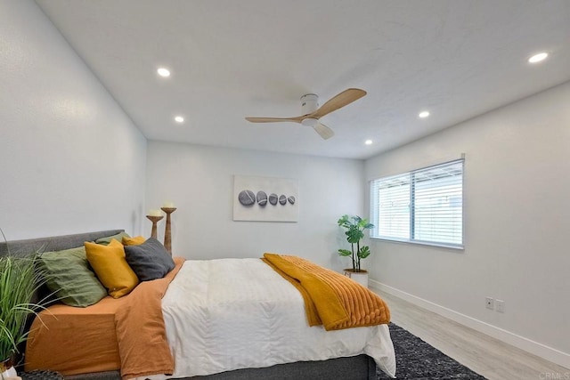 bedroom with ceiling fan and light hardwood / wood-style floors