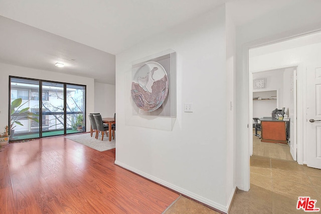 hallway with light hardwood / wood-style floors