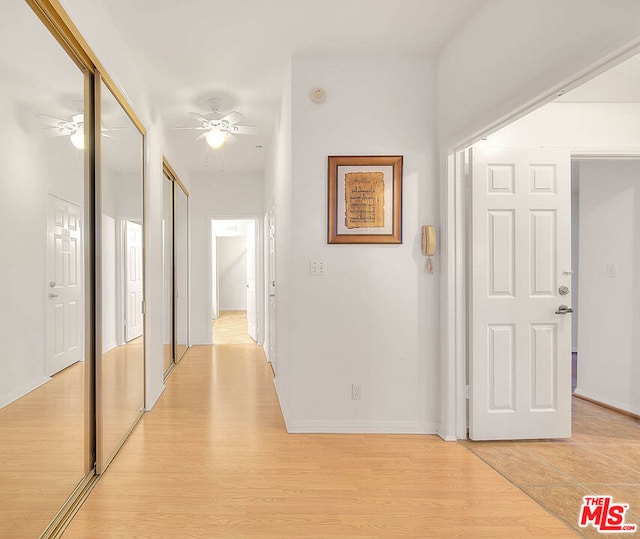 hall with light hardwood / wood-style floors