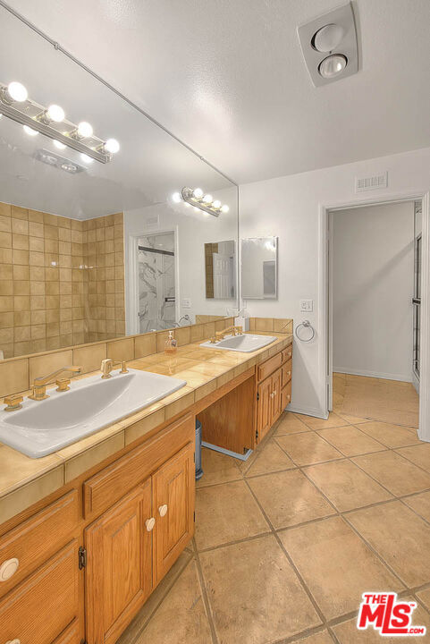 bathroom with vanity and tile patterned floors