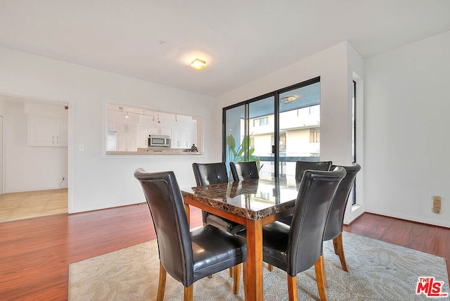 dining area with hardwood / wood-style floors