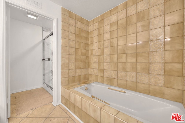 bathroom with tile patterned flooring and shower with separate bathtub