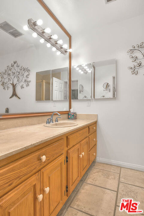 bathroom with vanity and tile patterned flooring