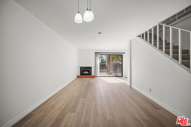 unfurnished living room with hardwood / wood-style floors