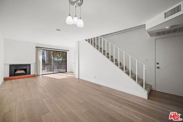 unfurnished living room with hardwood / wood-style floors