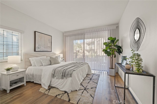 bedroom featuring hardwood / wood-style flooring and access to exterior