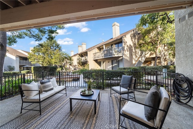 view of patio with a balcony and an outdoor hangout area