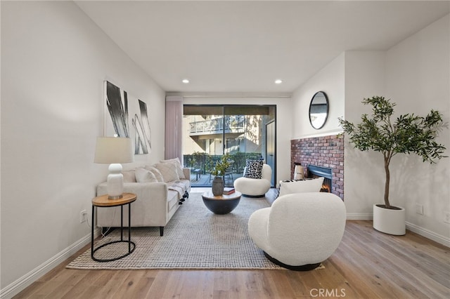 living room with a fireplace and light hardwood / wood-style floors