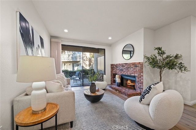 living room with wood-type flooring and a fireplace