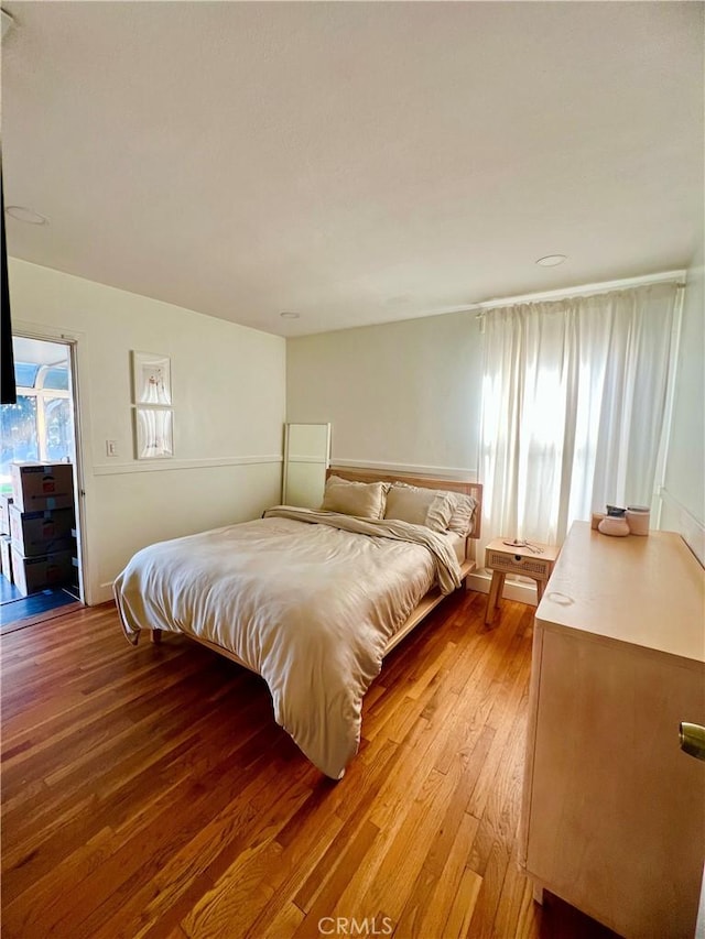 bedroom featuring access to outside and light hardwood / wood-style floors