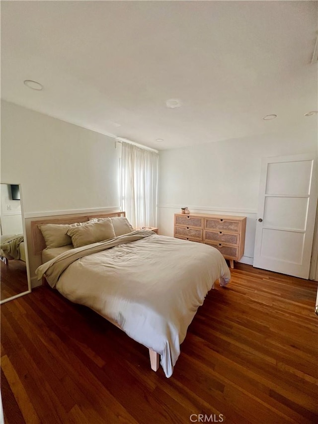 bedroom with dark wood-type flooring