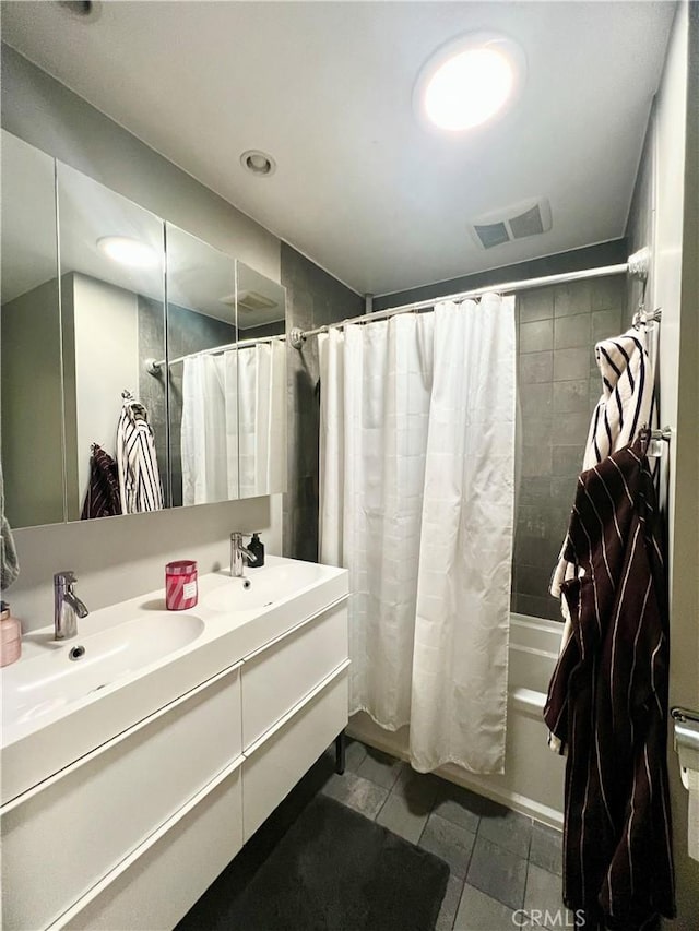 bathroom featuring shower / tub combo and vanity