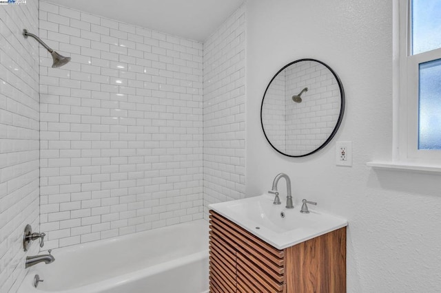 bathroom with vanity and tiled shower / bath combo