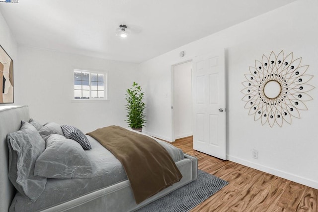 bedroom with hardwood / wood-style floors