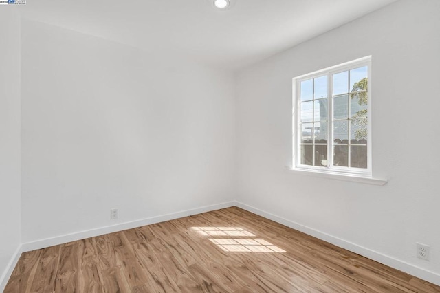 unfurnished room with light hardwood / wood-style floors