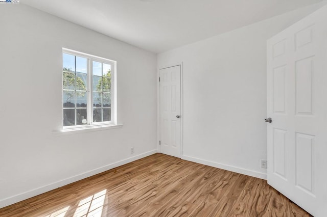 spare room featuring light hardwood / wood-style flooring