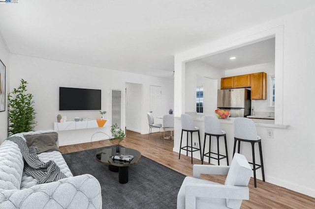 living room with light hardwood / wood-style flooring