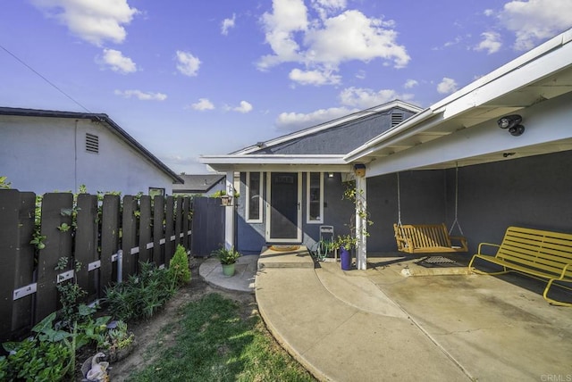 property entrance featuring a patio