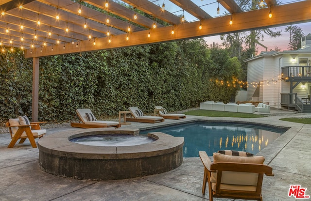 pool at dusk with a pergola, outdoor lounge area, a patio, and an in ground hot tub