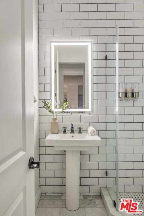 bathroom with a shower with shower door