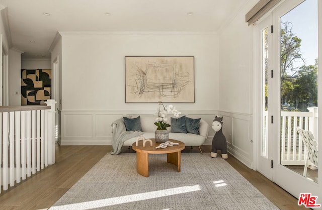 sitting room featuring hardwood / wood-style flooring and crown molding