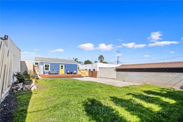 view of yard with a patio area and a deck