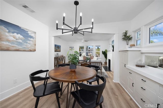 dining area with ceiling fan and light hardwood / wood-style floors