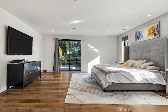 bedroom with dark hardwood / wood-style floors and access to exterior