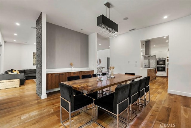 dining area with light hardwood / wood-style floors