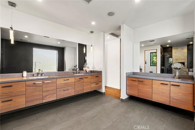 bathroom with vanity and a shower with shower door