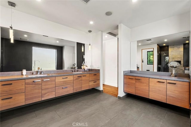 bathroom featuring vanity and a shower with door