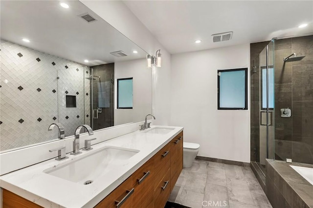 bathroom with an enclosed shower, vanity, and toilet