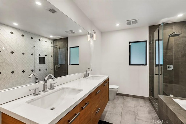 bathroom with vanity, an enclosed shower, and toilet