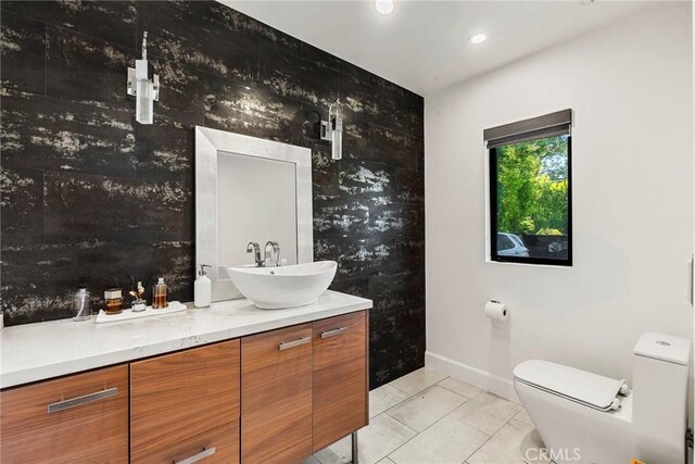 bathroom featuring tile patterned floors, vanity, and toilet