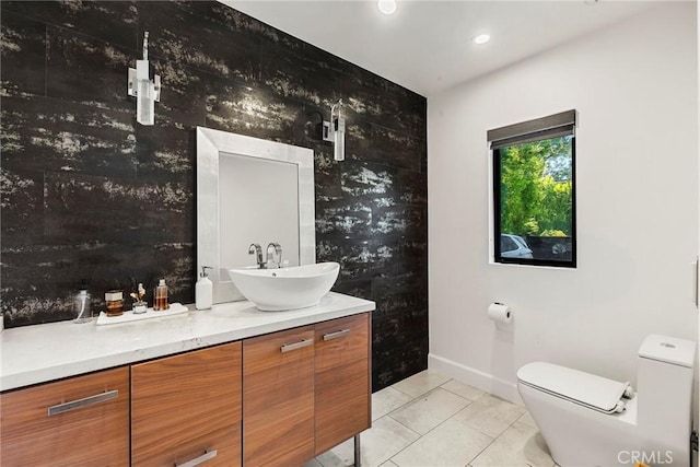 bathroom featuring vanity, tile patterned flooring, and toilet