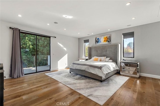 bedroom featuring hardwood / wood-style flooring and access to outside