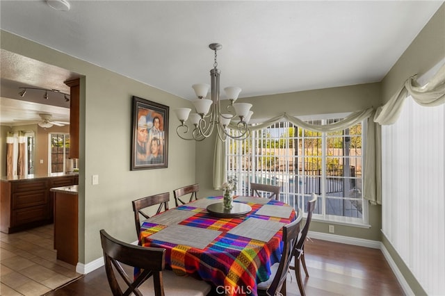 dining area featuring hardwood / wood-style floors and an inviting chandelier