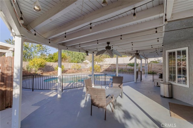 view of patio with ceiling fan and a fenced in pool