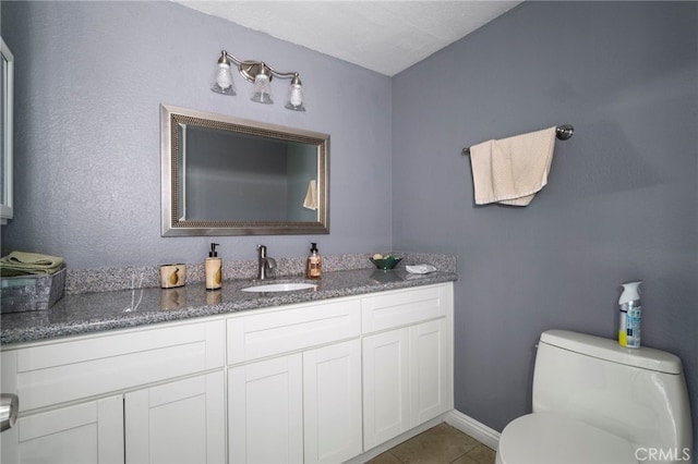 bathroom featuring tile patterned flooring, vanity, and toilet