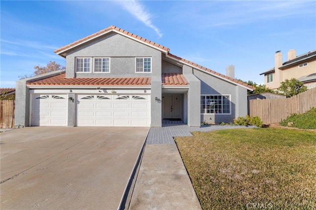 view of front of property with a garage and a front lawn