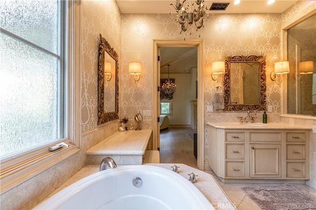 bathroom featuring a notable chandelier, vanity, visible vents, and wallpapered walls