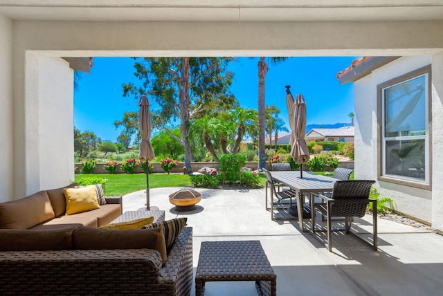 view of patio featuring an outdoor living space with a fire pit