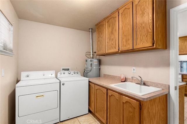 laundry area with sink, light tile patterned floors, cabinets, gas water heater, and washing machine and clothes dryer