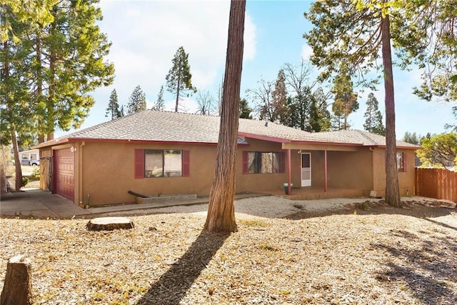 back of property featuring a garage