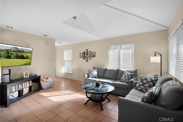 living room featuring lofted ceiling and light tile patterned floors