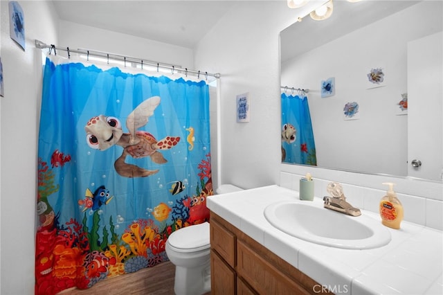 bathroom featuring vanity, toilet, a shower with shower curtain, and wood-type flooring