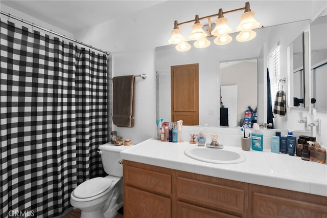 bathroom featuring vanity and toilet