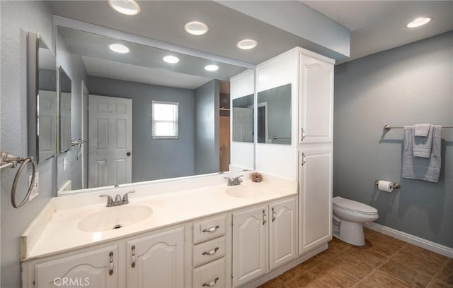 bathroom featuring tile patterned flooring, vanity, and toilet