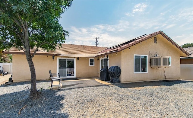 back of property with a patio area